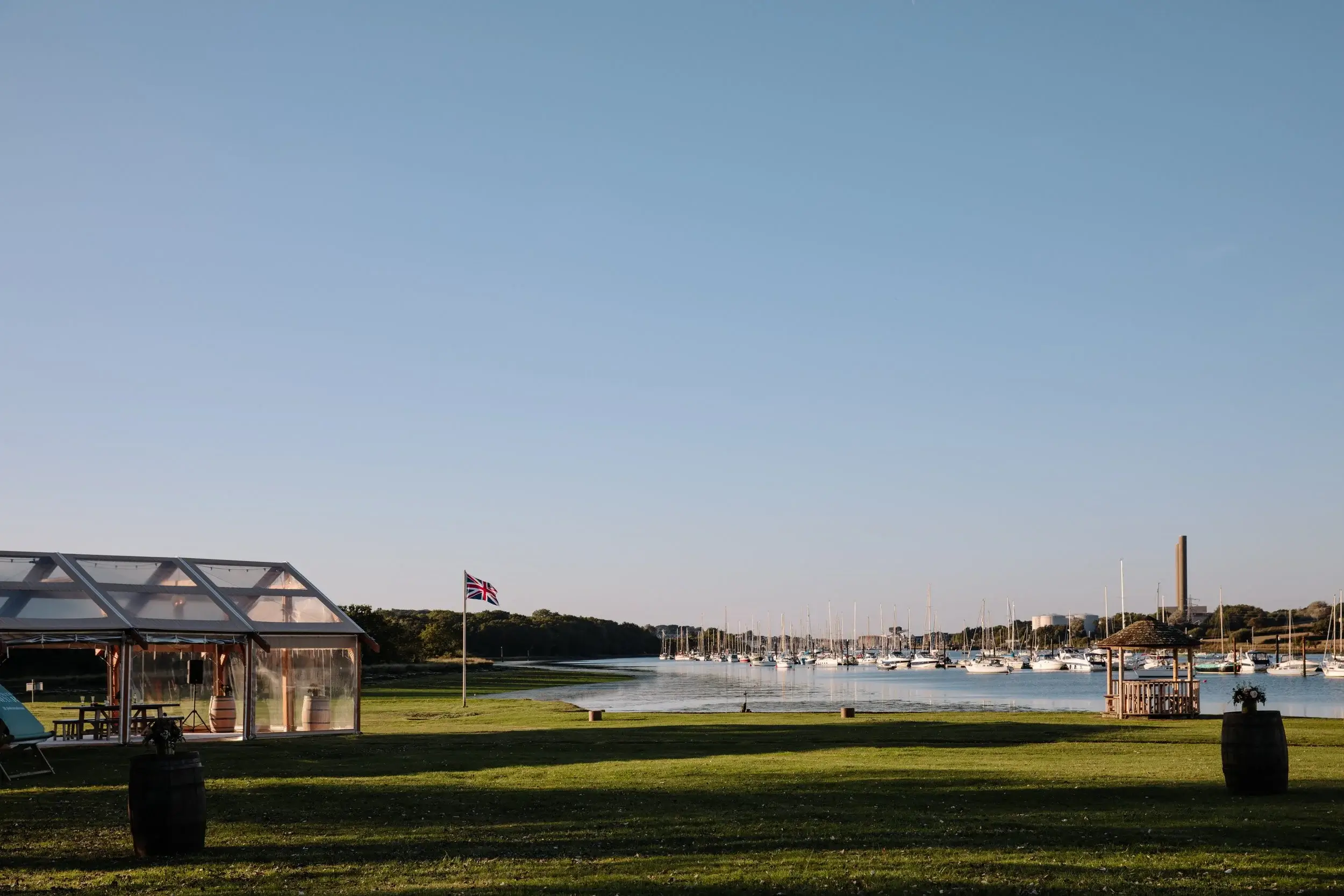 Waterside marquee with a Union Jack flag overlooking a marina full of yachts on the Isle of Wight