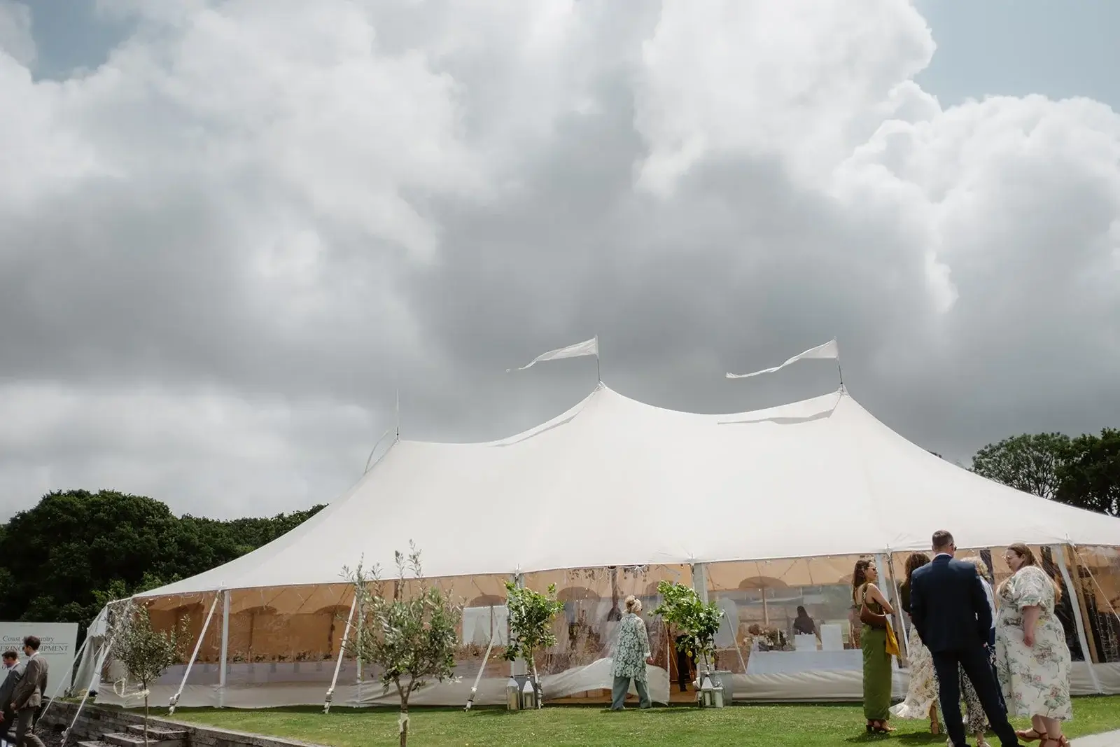 Sailcloth marquee interior with suspended canopy of greenery and hanging lemons