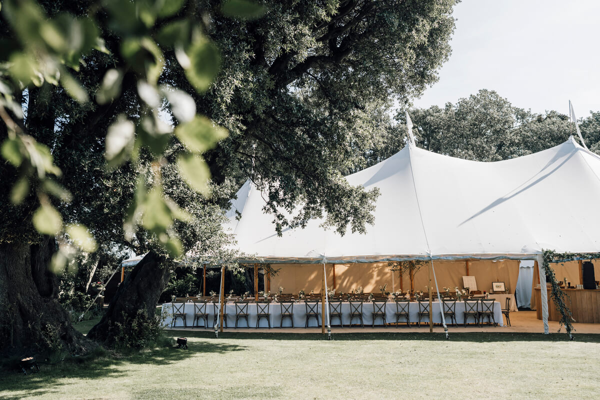 Sailcloth marquee framed by a large oak in the grounds of The Towers, Yarmouth