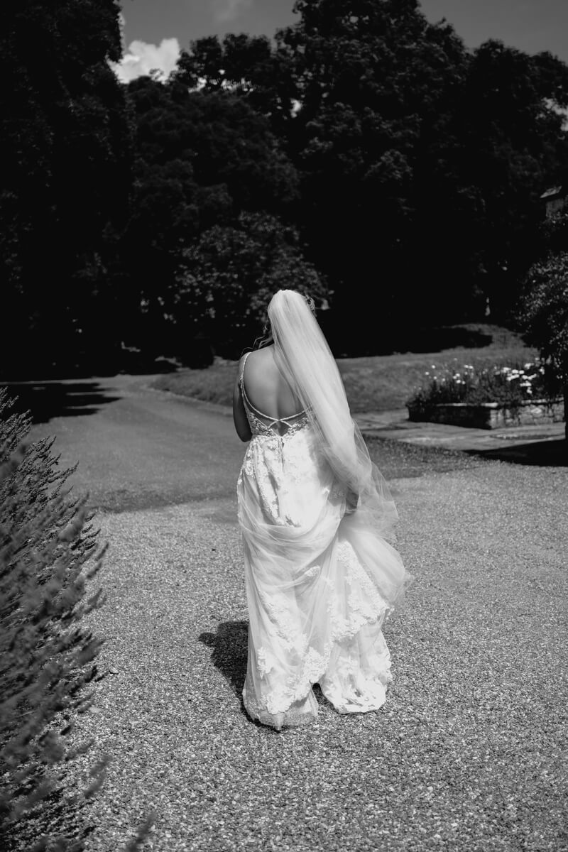 Bride in the gardens at Barton Manor in black and white