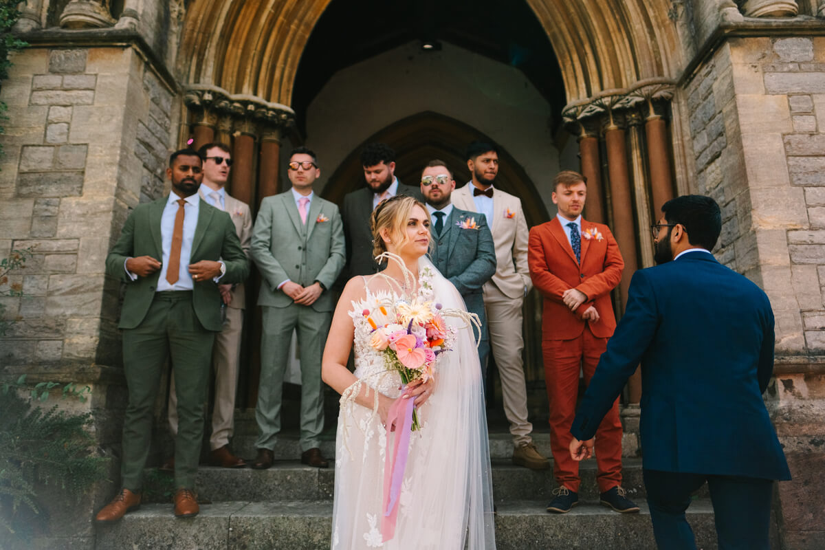Bride and groomsmen on the manor steps