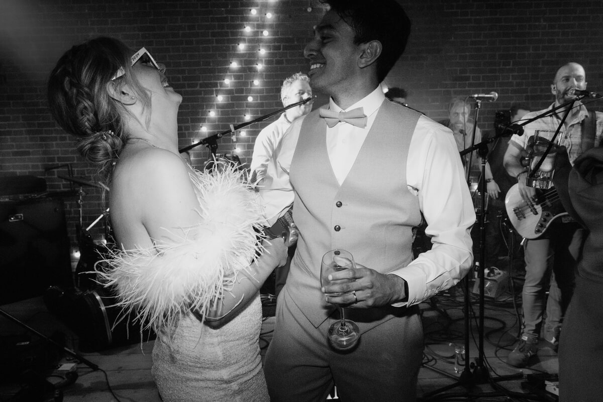 Lily & Ash dancing to the live band in black and white