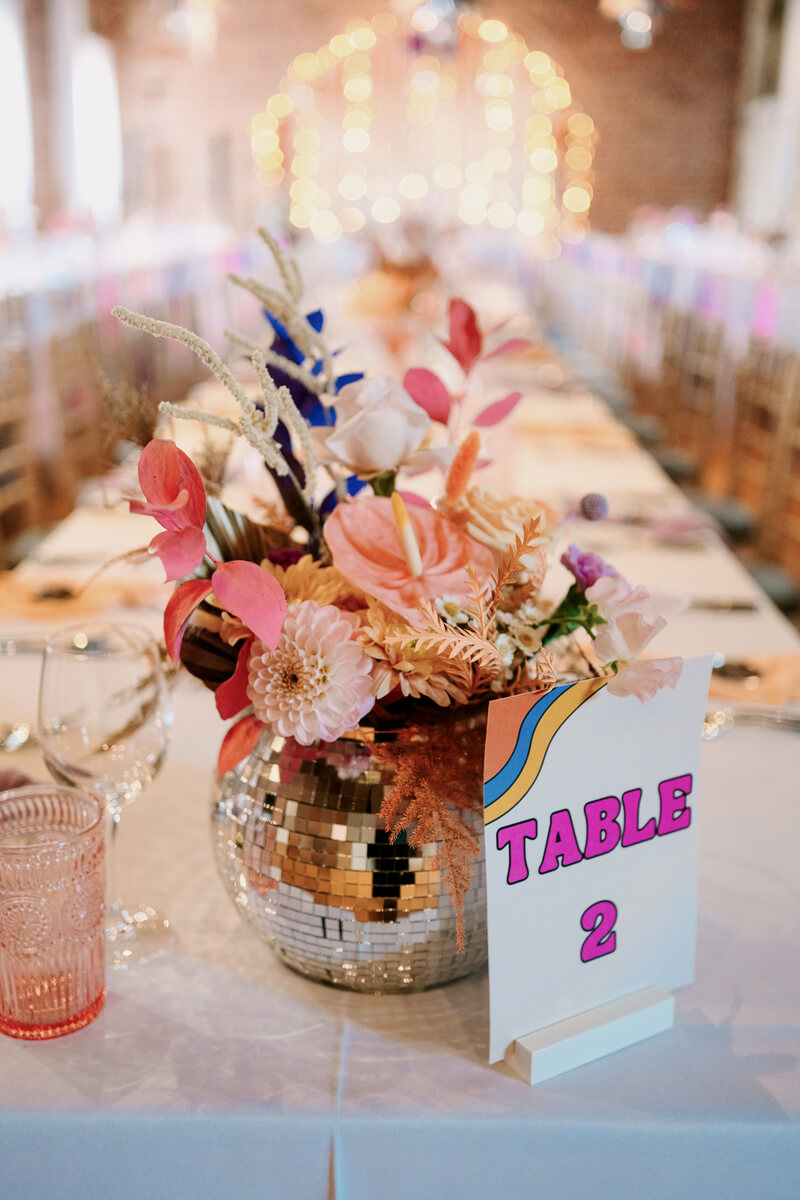 Mirror-ball bowl centrepiece with pink blooms
