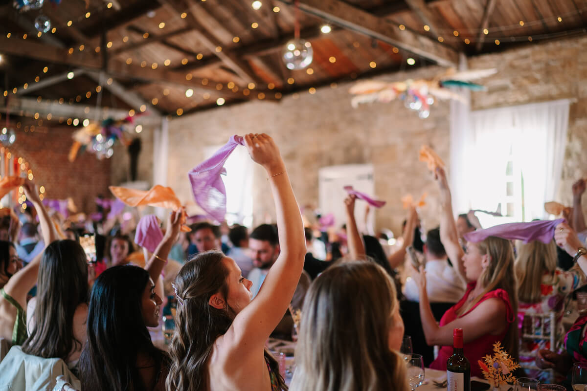 Dancefloor crowd waving pink napkins in the barn